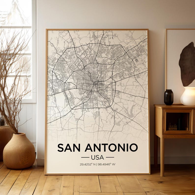 Puede incluir: Una impresi&oacute;n de mapa en blanco y negro de San Antonio, Texas, EE. UU. El mapa muestra las calles y los puntos de referencia de la ciudad. El texto "San Antonio - USA - 29.4252&deg; N | 98.4946&deg; W" est&aacute; impreso debajo del mapa.