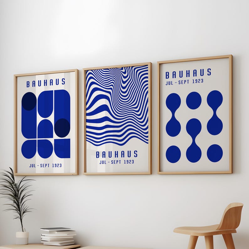 May include: Three framed prints with a Bauhaus theme. The prints feature geometric shapes, abstract patterns, and the text "BAUHAUS JUL-SEPT 1923".