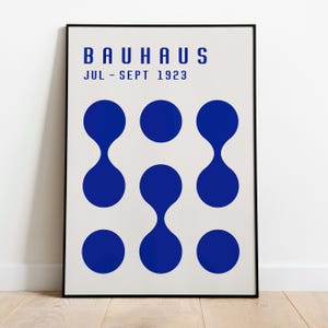 May include: A black and white poster with the text "BAUHAUS JUL - SEPT 1923" and a pattern of nine blue circles.