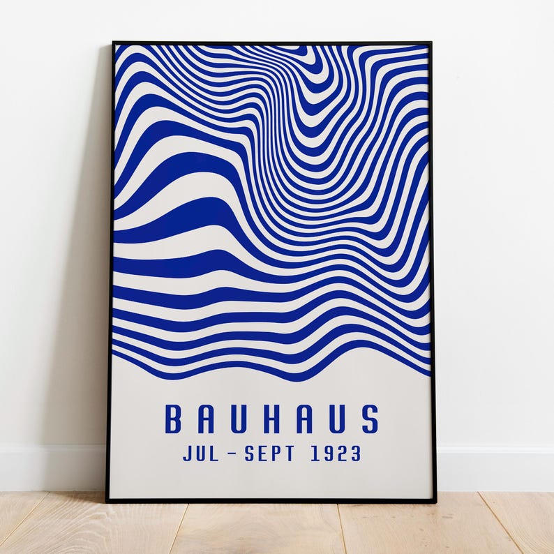 May include: A black framed poster with a blue and white abstract design. The poster has the text "BAUHAUS JUL-SEPT 1923" at the bottom.
