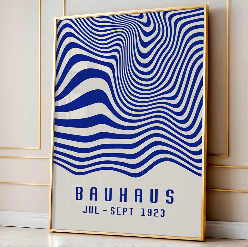 May include: A blue and white abstract art print with the text "BAUHAUS JUL - SEPT 1923" in a gold frame.