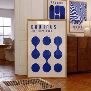 May include: Three Bauhaus style posters with blue and white geometric designs. The posters feature the text "Bauhaus Jul - Sept 1923".