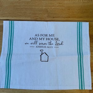 May include: White kitchen towel with teal stripes and the text "AS FOR ME AND MY HOUSE, we will serve the Lord. - JOSHUA 24:15" with a small house icon.