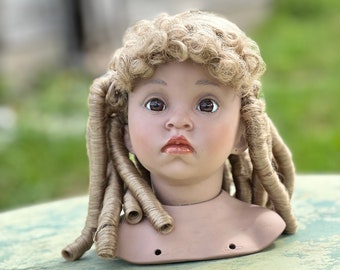 Blond Dutchess style doll wig.