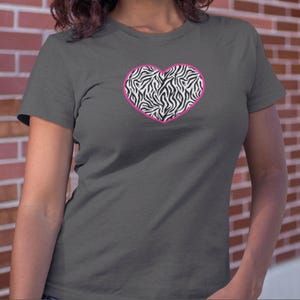 May include: A charcoal gray t-shirt with a pink outlined heart featuring a zebra print pattern.