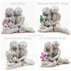 May include: Four ceramic figurines depicting a couple holding a baby with different types of wings. The figurines are all white with a pearlescent finish. The wings include angel wings, monarch butterfly wings, pastel butterfly wings, and vivid butterfly wings.