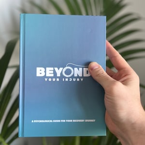 May include: A blue and green gradient paperback book with the title "Beyond Your Injury" in white text. The book is a psychological guide for your recovery journey.