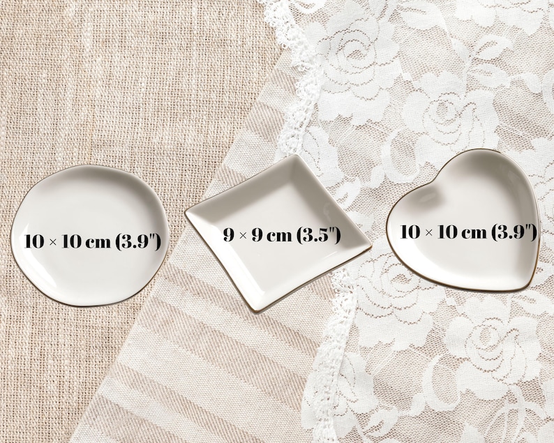 May include: Three white ceramic trinket dishes in round, diamond, and heart shapes. The round dish measures 10 x 10 cm (3.9 inches), the diamond dish measures 9 x 9 cm (3.5 inches), and the heart-shaped dish measures 10 x 10 cm (3.9 inches).