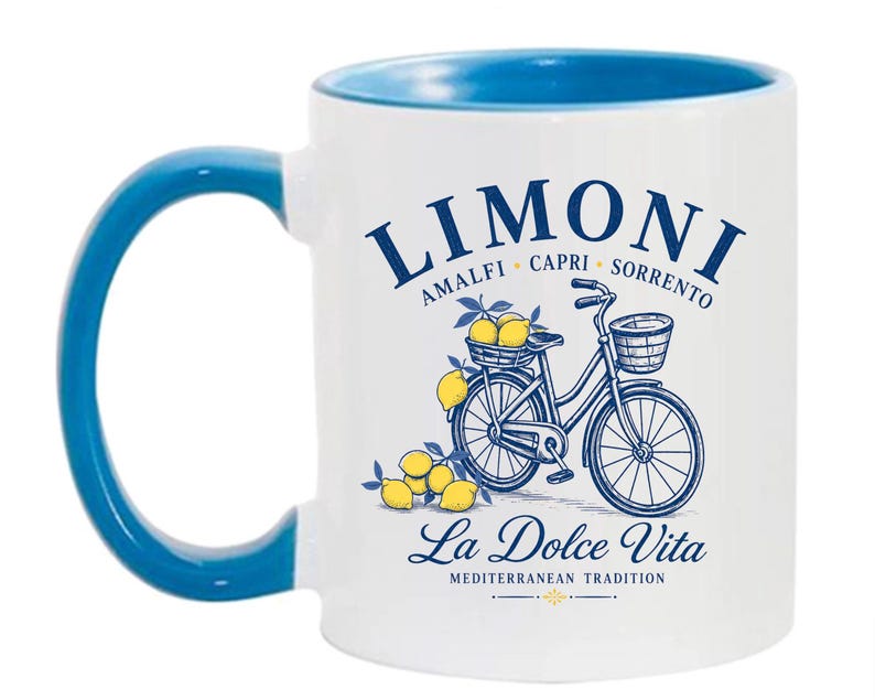 May include: A white ceramic mug with a blue interior and handle. The front features a blue graphic of a bicycle with a basket of yellow lemons, text reading LIMONI AMALFI CAPRI SORRENTO, La Dolce Vita, and MEDITERRANEAN TRADITION in blue ink.