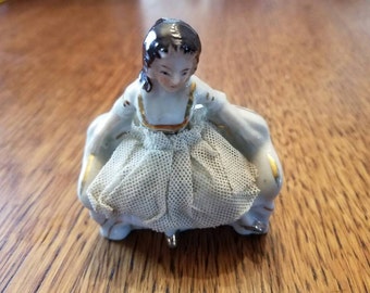 Little Porcelain Girl Sitting on a couch with a Fabric Dress  Japan Vintage