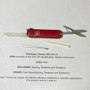 May include: A red Victorinox Classic SD pocket knife with a keyring, tweezers, and toothpick. The blade has been removed for TSA compliance. The knife is 58mm long.