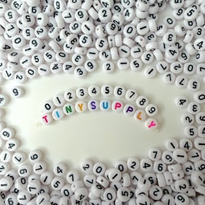 Cuentas individuales de 7 mm (0-9), redondas, blancas y con números negros