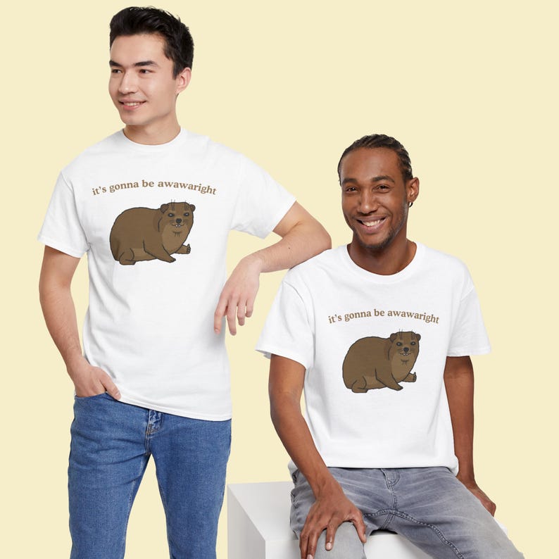 t-shirt with a cute hand-drawn hyrax illustration and the phrase ‘it’s gonna be awawaright’ — funny wholesome animal meme graphic tee.