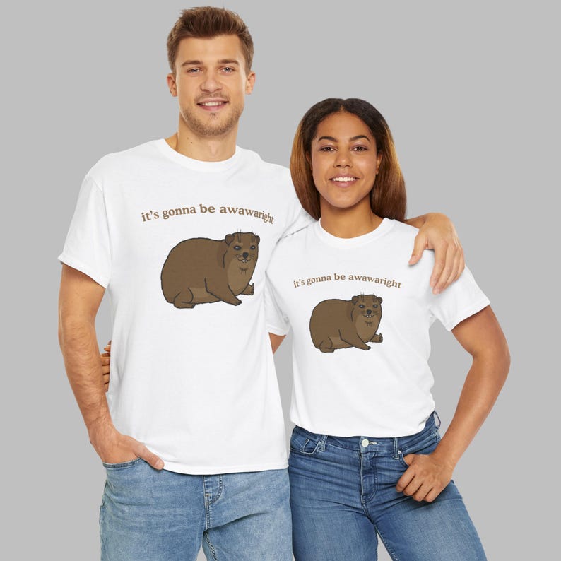 t-shirt with a cute hand-drawn hyrax illustration and the phrase ‘it’s gonna be awawaright’ — funny wholesome animal meme graphic tee.