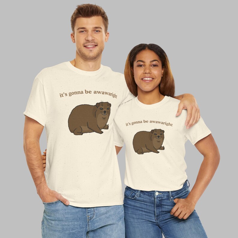 t-shirt with a cute hand-drawn hyrax illustration and the phrase ‘it’s gonna be awawaright’ — funny wholesome animal meme graphic tee.