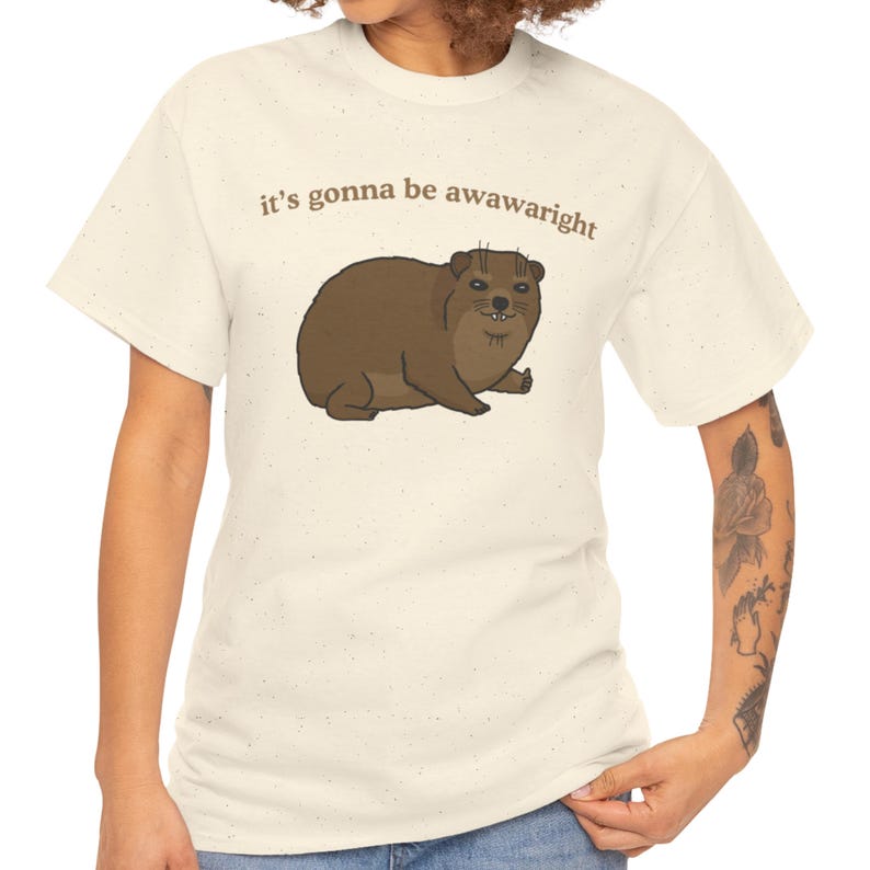 t-shirt with a cute hand-drawn hyrax illustration and the phrase ‘it’s gonna be awawaright’ — funny wholesome animal meme graphic tee.