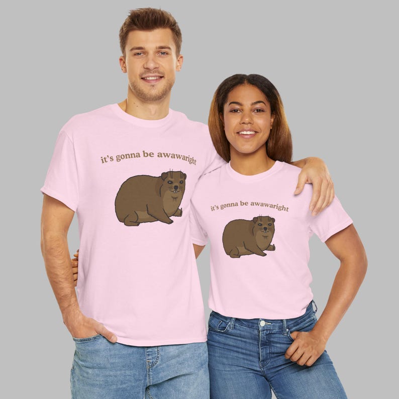 t-shirt with a cute hand-drawn hyrax illustration and the phrase ‘it’s gonna be awawaright’ — funny wholesome animal meme graphic tee.