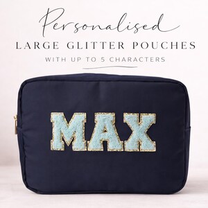 May include: A navy blue, rectangular glitter pouch with the name "MAX" in light blue, fluffy letters. The pouch has a gold zip and the text "Personalised Large Glitter Pouches With Up To 5 Characters" is above it.