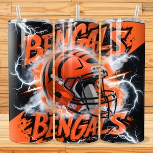 May include: Three black and orange stainless steel tumblers with a white and orange football helmet graphic and the text "Bengals" in black and orange.