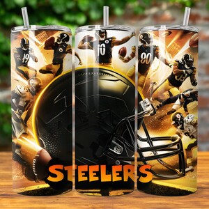 May include: A stainless steel tumbler with a black and gold design featuring Pittsburgh Steelers players and a football helmet. The tumbler has the word "Steelers" printed on it.