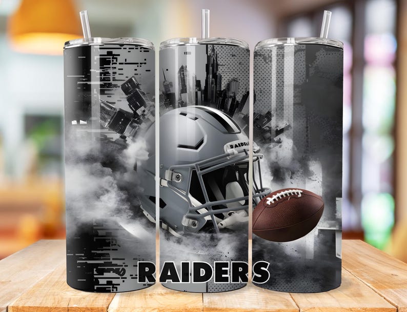 May include: Three stainless steel tumblers with a black and white design featuring a football helmet, a football, and the word "RAIDERS".