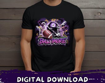 May include: Black t-shirt with a football helmet and ball design, featuring the word "BALTIMORE" in purple graffiti lettering. The design includes purple and yellow accents. The text "DIGITAL DOWNLOAD - PNG-SVG" is at the bottom.