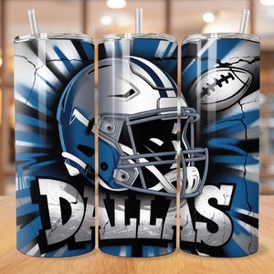 May include: A set of three stainless steel tumblers with lids and straws. Each tumbler features a design with a football helmet, football, and the word "DALLAS" in bold, white letters against a blue and white background.