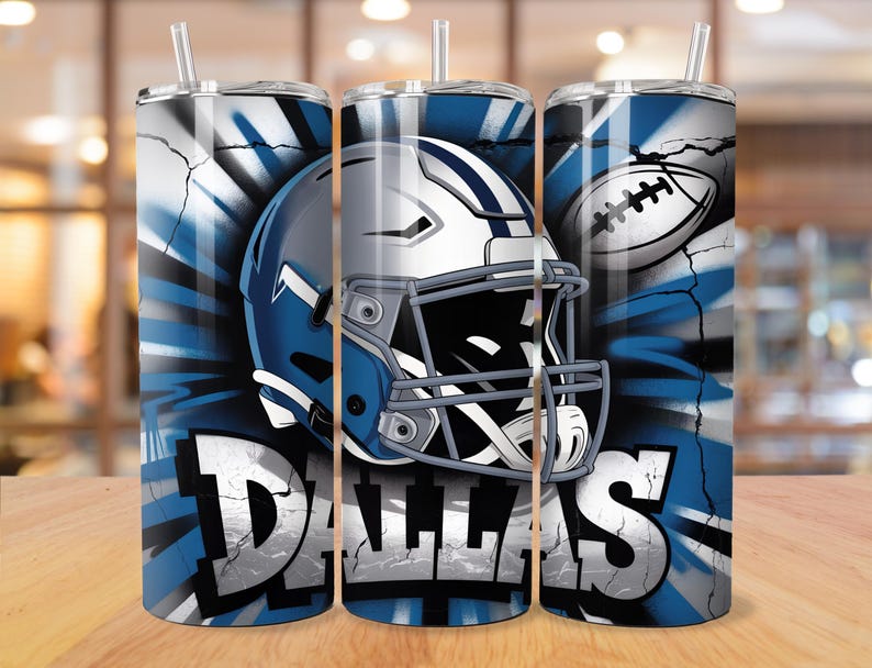 May include: A set of three stainless steel tumblers with lids and straws. Each tumbler features a design with a football helmet, football, and the word "DALLAS" in bold, white letters against a blue and white background.