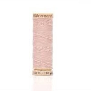 May include: A spool of light pink thread on a wooden bobbin. The spool is labeled "Gutermann" and "100 m - 110 yd".