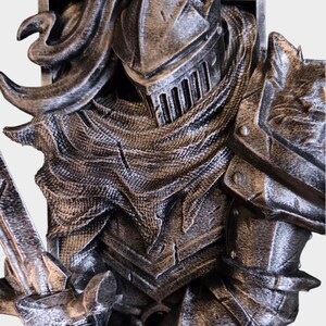 May include: A detailed, close-up view of a knight's armor, rendered in shades of silver and gray. The image highlights the intricate textures of the helmet, chainmail, and shoulder guard, suggesting a medieval or fantasy theme. The armor appears to be a decorative piece.