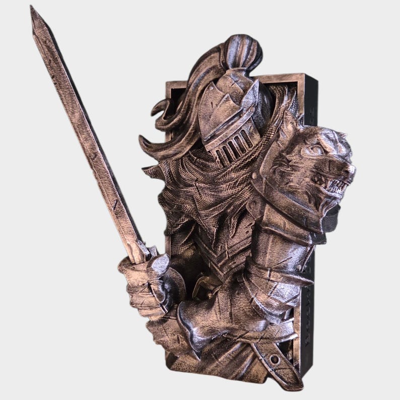 May include: A detailed sculpture of a knight in silver armor, holding a sword. The knight's helmet and shoulder armor are intricately designed. A wolf's head is sculpted on the shoulder. The sculpture is mounted on a black rectangular base.