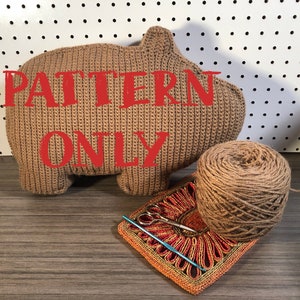 May include: Crochet pattern for a brown amigurumi animal, with the words "PATTERN ONLY" in red text. The pattern includes yarn, a crochet hook, and scissors.