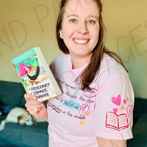 May include: A pink t-shirt with the text "...are one end the universe, the shoe, the other, then the two of us..." and a book graphic. The book cover reads "Problematic Summer Romance" by Ali Hazelwood.