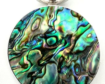 May include: Abalone shell pendant with a silver-tone bail. The iridescent shell displays swirling patterns of green, blue, and purple. The pendant is round and has a polished finish, suitable for necklaces.