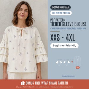 May include: A cream-coloured blouse with a small purple floral print, featuring three-tiered gathered sleeves and a self-tie bow at the neckline. The text includes PDF SEWING PATTERN, TIERED SLEEVE BLOUSE, XXS - 4XL, and BONUS FREE WRAP SHAWL PATTERN.