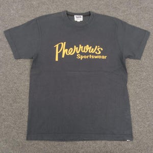 May include: A black t-shirt with a gold "Pherrwous' Sportswear" logo.