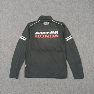 May include: Black zip-up jacket with white accents and the text "MUGEN 無限 HONDA" in red and white. Features the "elf Lubricants" logo and white stripes on the sleeves. A sporty, athletic jacket.