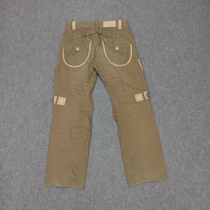 May include: Brown cargo pants with beige trim and multiple pockets. The pants have a belt loop and a button closure.
