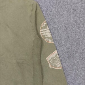 May include: Olive green sweatshirt with two patches. One patch reads "YACHT" in a circular design. The other patch reads "USSS PERRY". The sweatshirt is made of a soft material.