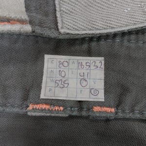 May include: A white tag with black writing, showing measurements in inches. The tag reads "C 80 A 16.5 32 N 10 L 41 W 335 F D".