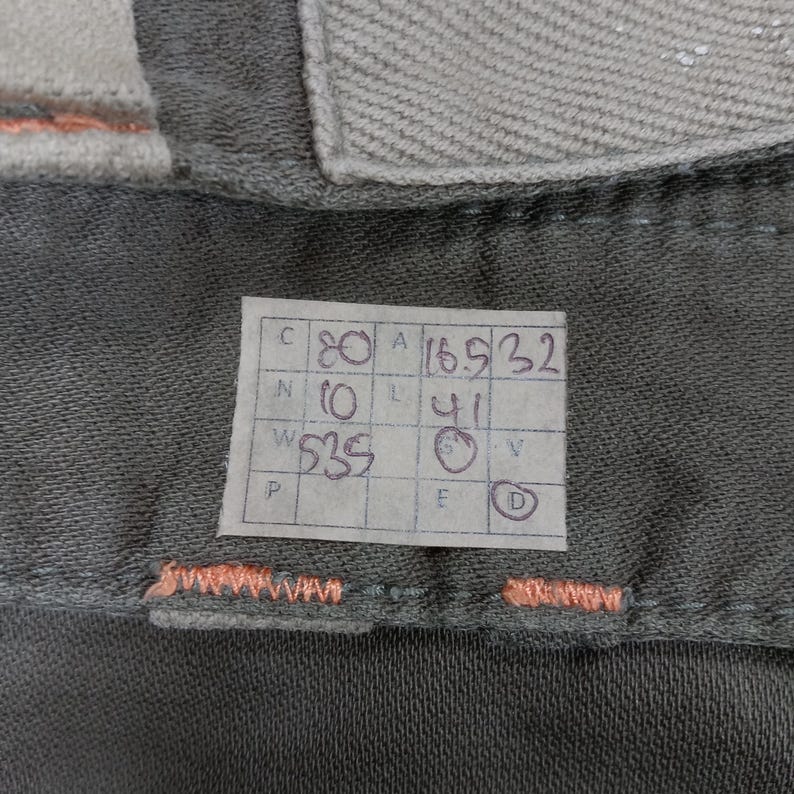May include: A white tag with black writing, showing measurements in inches. The tag reads "C 80 A 16.5 32 N 10 L 41 W 335 F D".