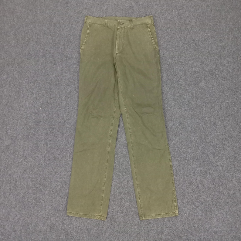 May include: A pair of olive green trousers with a straight leg and a button fly.