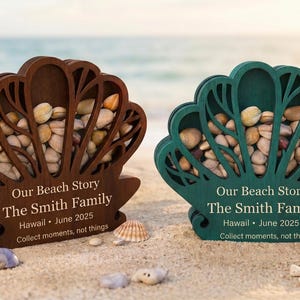 May include: Two seashell-shaped wooden boxes, one brown and one teal, filled with small stones and shells. The boxes have a decorative cut-out design and text that reads "Our Beach Story" and "Collect moments, not things."