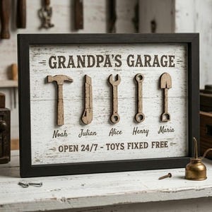 May include: A framed wooden sign with the text "GRANDPA'S GARAGE" and the words "OPEN 24/7 - TOYS FIXED FREE." The sign features wooden cutouts of tools and names: Noah, Julian, Alice, Henry, and Maria.