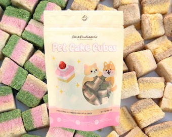 May include: A package of "Pet Cake Cubes" pet treats, with a strawberry cake illustration and two cartoon pets. The treats are surrounded by colorful, layered cubes in pink, green, and yellow. The package reads "Freeze Dried Pet Treats for Cats & Dogs."