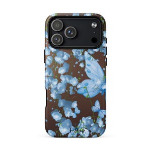 May include: A white ceramic mug with a black handle and the text "But First, Coffee" in a bold, black font. The mug is set against a blurred background, suggesting a cozy setting. The mug appears to be approximately 4 inches tall.