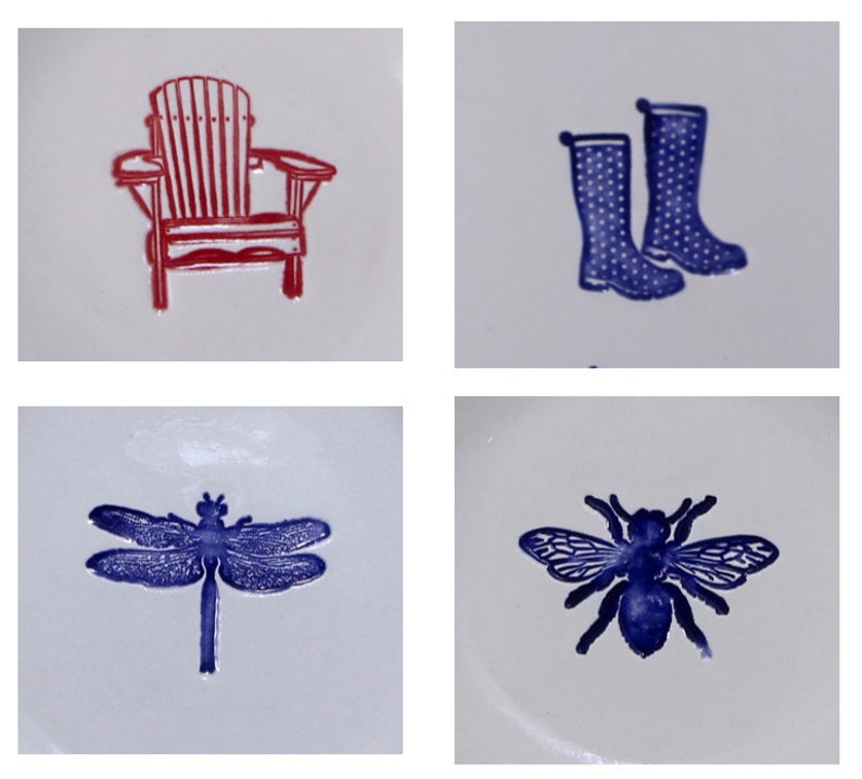 May include: Four ceramic tiles with different designs. The top left tile features a red Adirondack chair. The top right tile features two blue rain boots. The bottom left tile features a blue dragonfly. The bottom right tile features a blue bee.