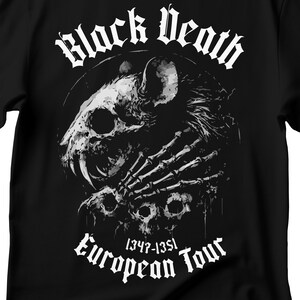 May include: Black t-shirt with a white graphic of a skull and skeletal hand. The text reads "Black Death" above and "European Tour 1347-1351" below. The design is gothic in style.