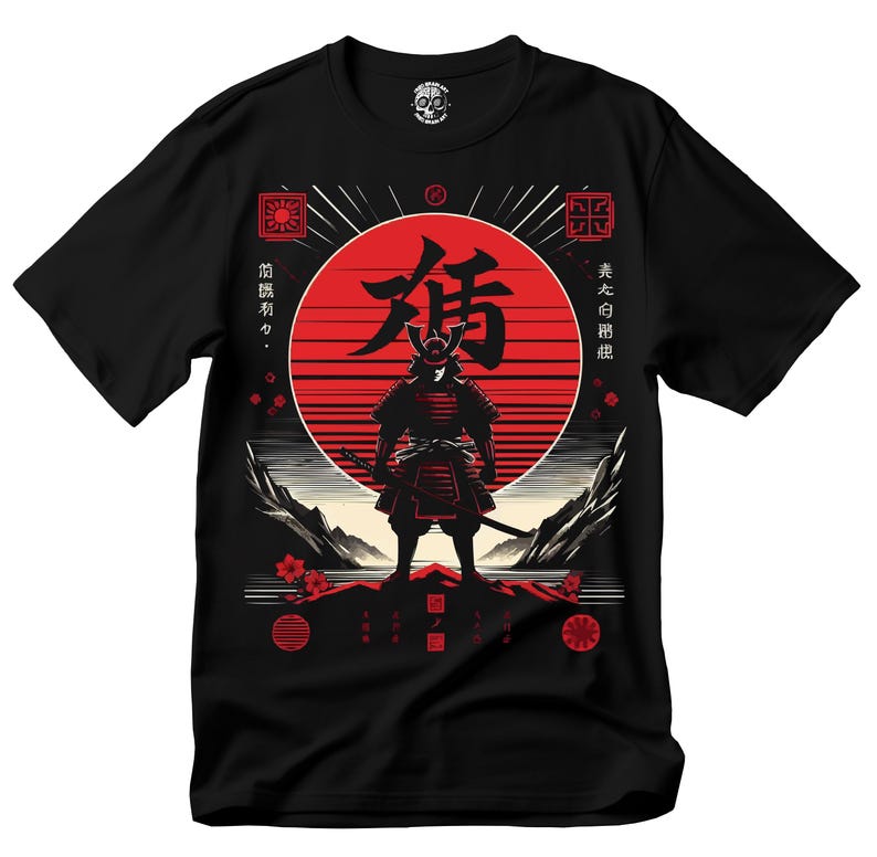 May include: Black t-shirt featuring a red and black graphic of a samurai warrior standing in front of a red sun. The design includes Japanese text and decorative elements. The shirt is a crew neck and made of a soft material.