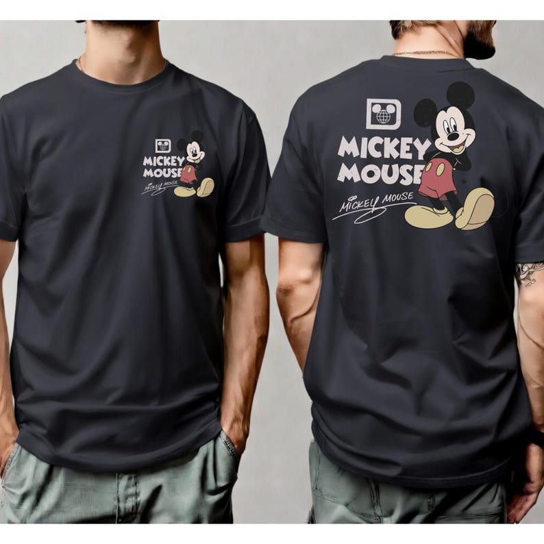 May include: Dark gray t-shirt featuring Mickey Mouse. The front of the shirt has a small Mickey Mouse graphic with the words "Mickey Mouse". The back of the shirt has a larger Mickey Mouse graphic with the words "Mickey Mouse".